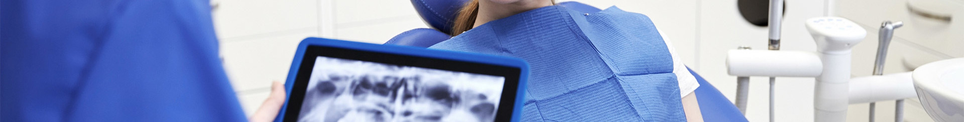 dentist with x-ray on tablet pc and patient girl